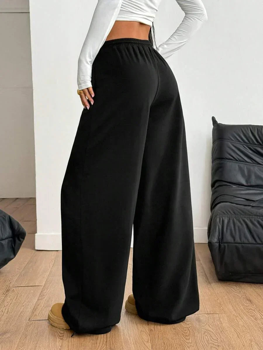 Black cotton baggy sweatpants with elastic waistband from HUSTLE801, relaxed fit, streetwear style