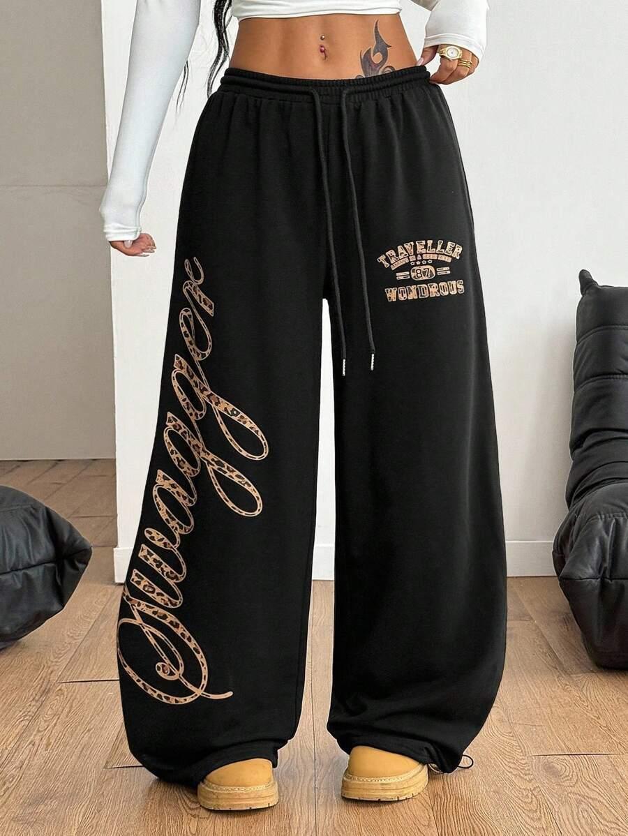 Black cotton baggy sweatpants with 'Swagger' and 'Traveller Wondrous' graphics, HUSTLE801
