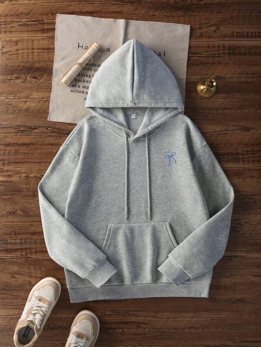 HUSTLE801 That Girl grey cotton hoodie with blue bow embroidery, laid flat with sneakers