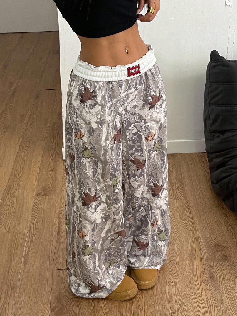 COOLIVE camo wide-leg pants with white elastic waistband in grey cotton, leaf print, on wooden floor