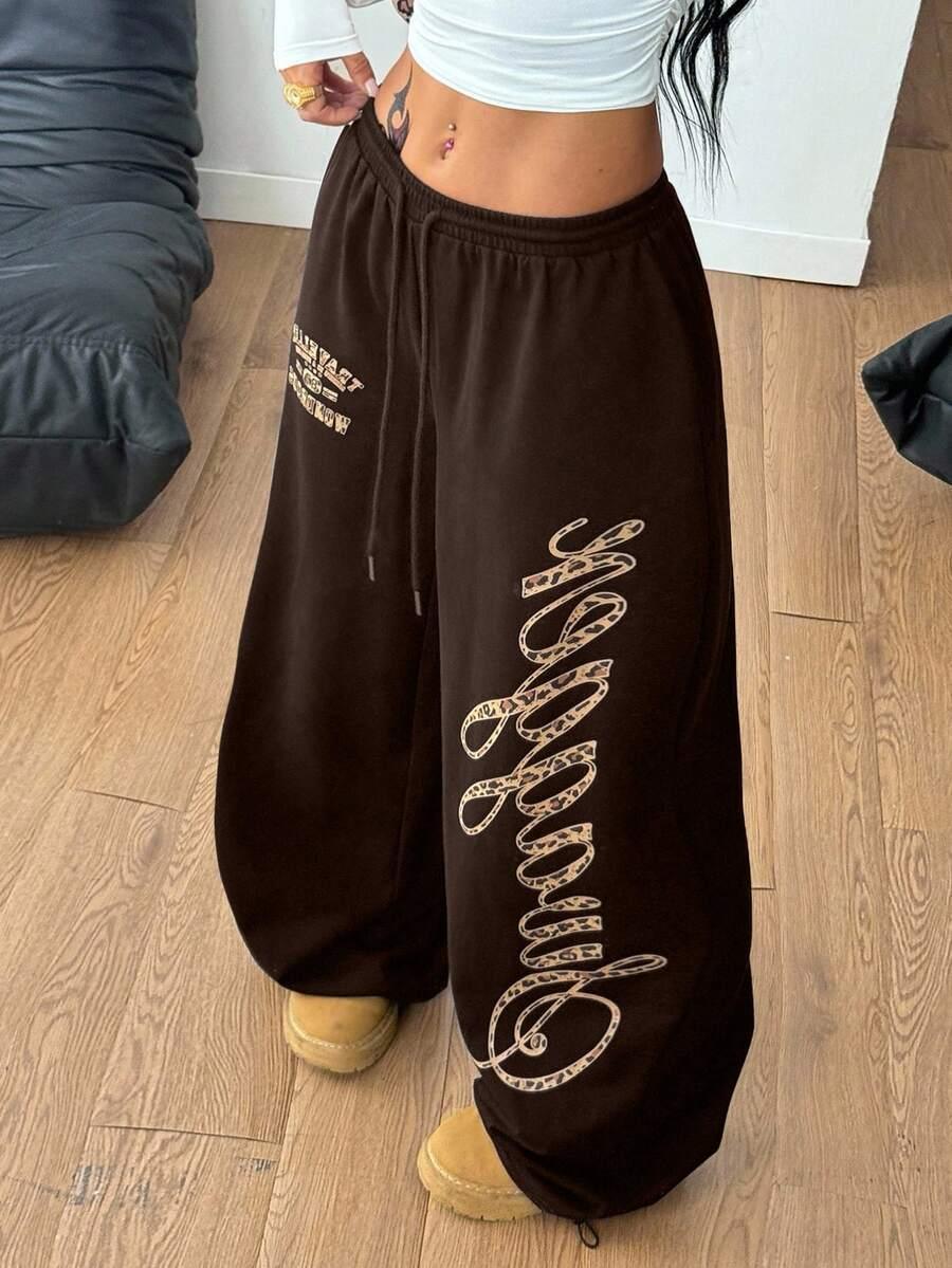 Brown cotton HUSTLE801 baggy sweatpants with cheetah print 'angelbaby' text, cozy fit