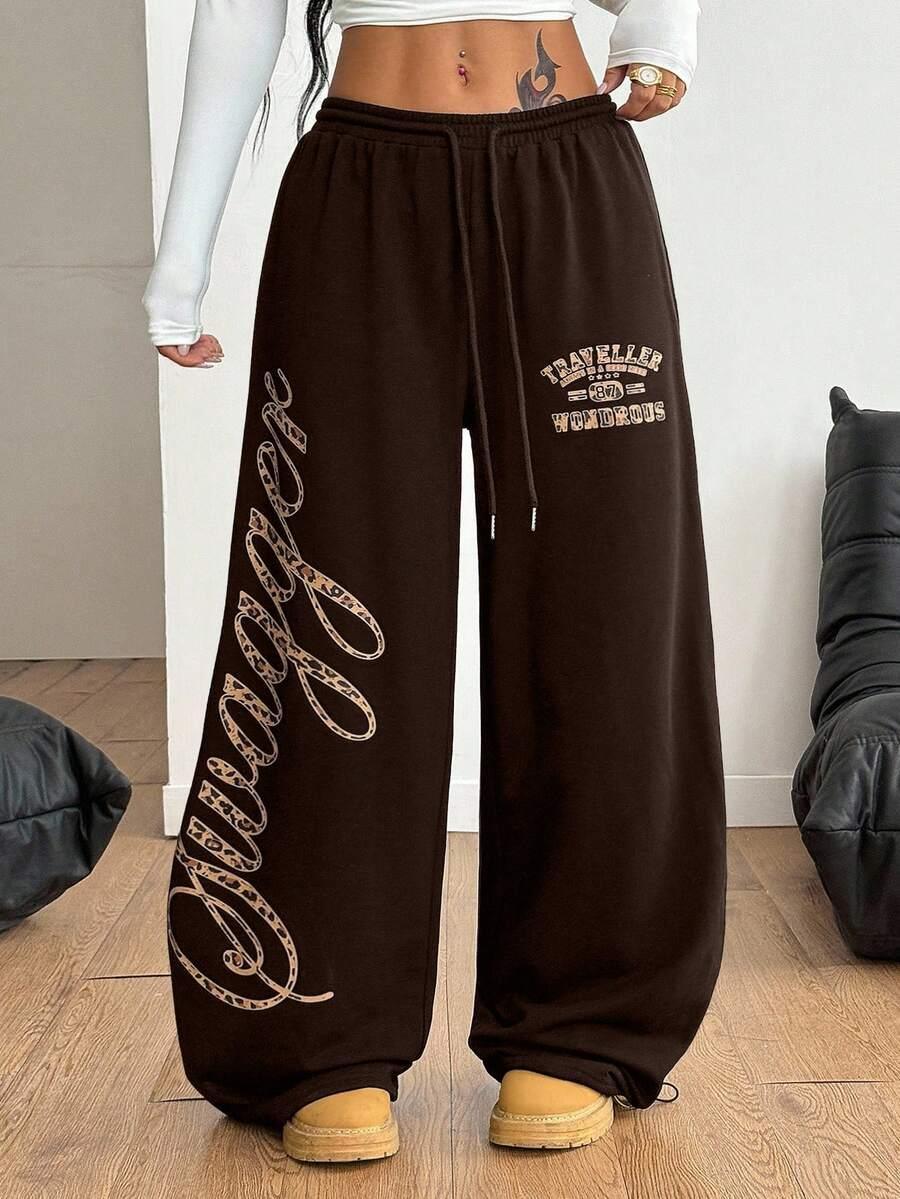 Brown cotton HUSTLE801 Traveller 801 Wondrous baggy sweatpants with swag script and elastic waistband