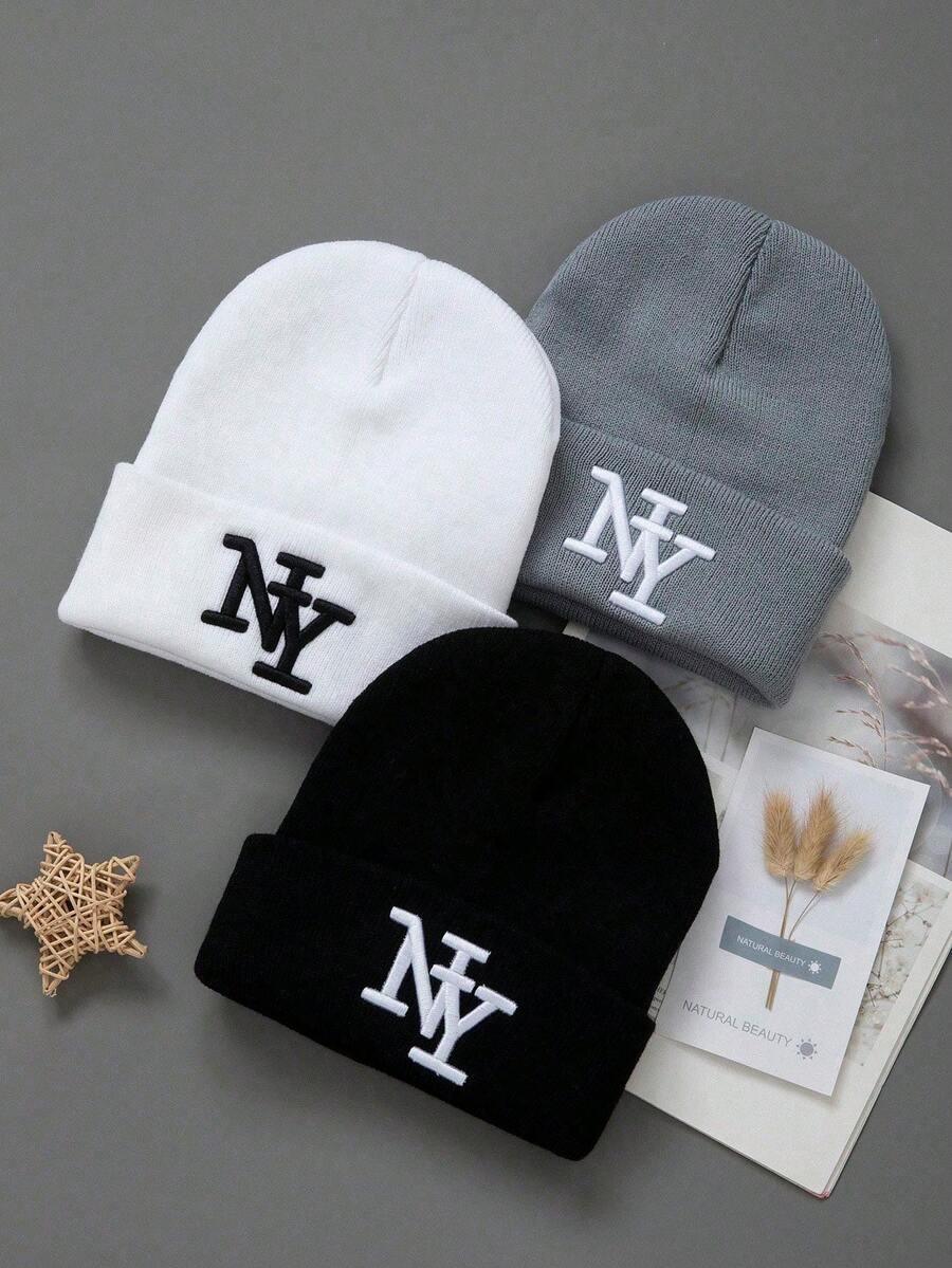 NY logo cotton beanies in black, white, and gray from HUSTLE801 on a flat lay background