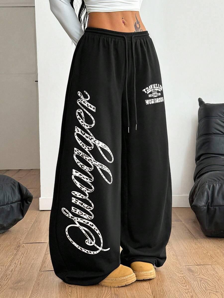 Black cotton HUSTLE801 Swagger wide-leg sweatpants with white graphic lettering, relaxed fit