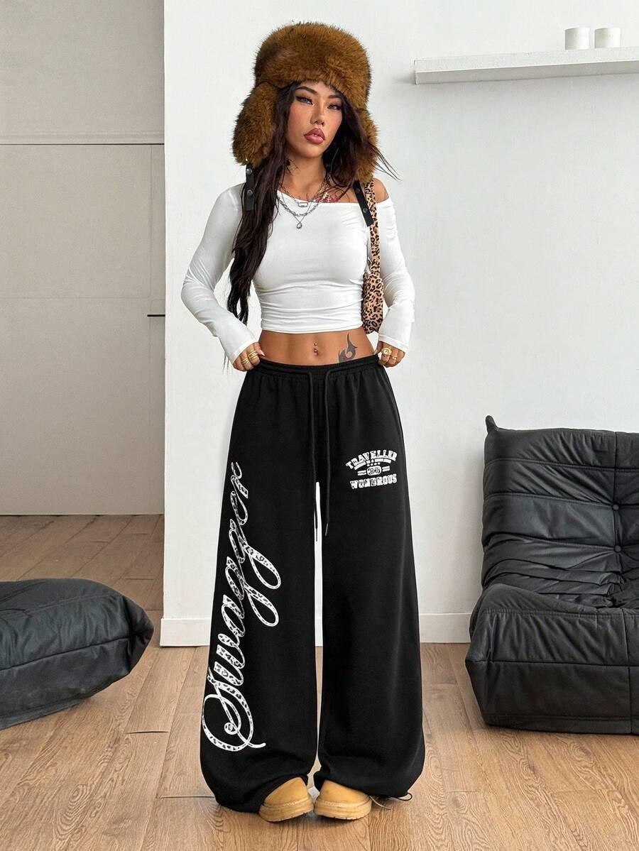 Black cotton Swaggy wide-leg sweatpants with white graphic print by HUSTLE801