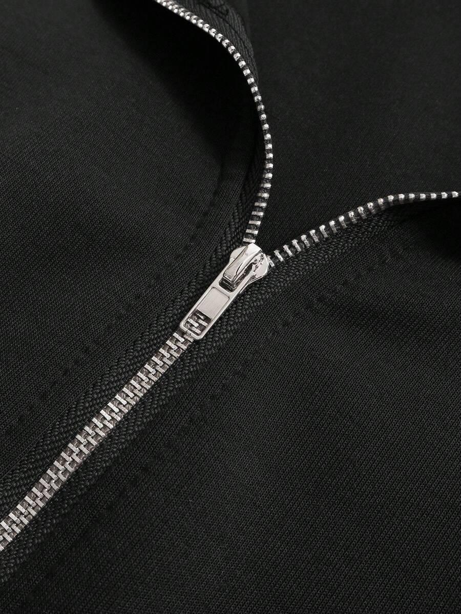Close-up of black cotton jacket zipper, showcasing silver metal hardware and fine stitching detail