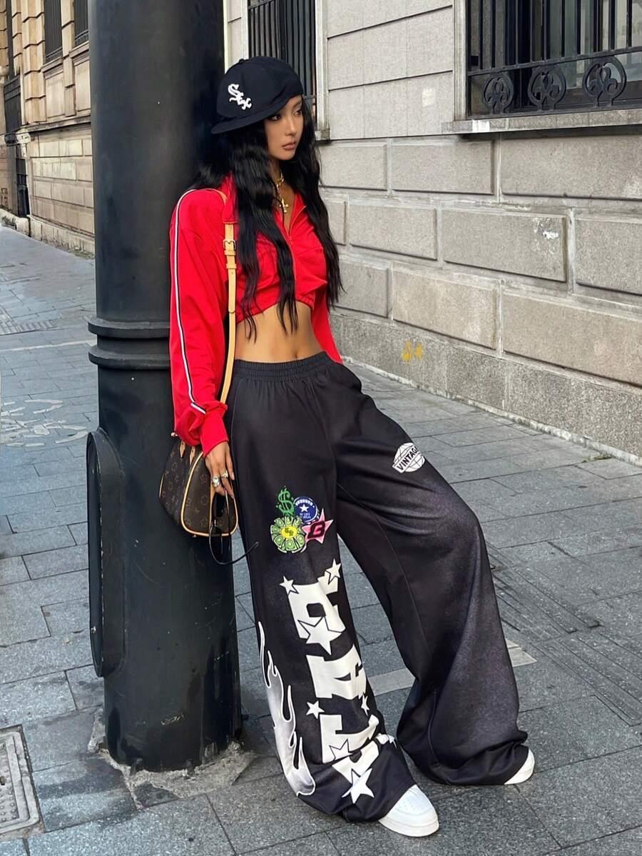 Woman wearing red crop top, black cotton wide-leg HUSTLE801 graffiti pants, street style