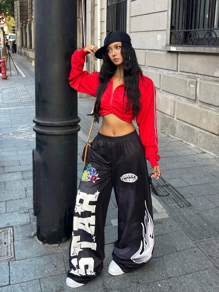 Woman wears black STAR VINTAGE baggy pants, red cropped jacket, black cap, cotton streetwear style
