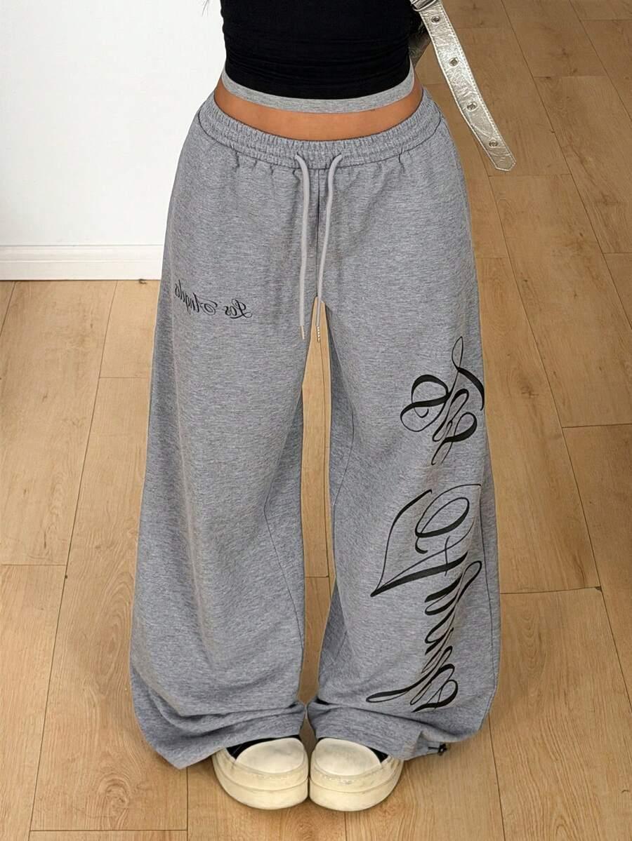 Grey cotton baggy sweatpants with black script print, ultra-comfy loungewear from HUSTLE801