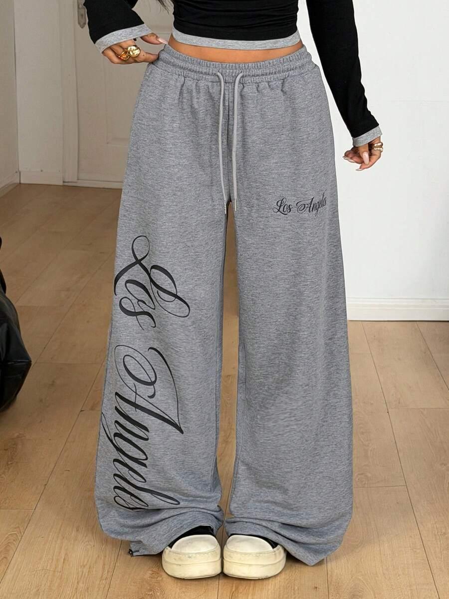 Gray cotton Los Angeles wide-leg sweatpants with bold script print, drawstring waist, streetwear style
