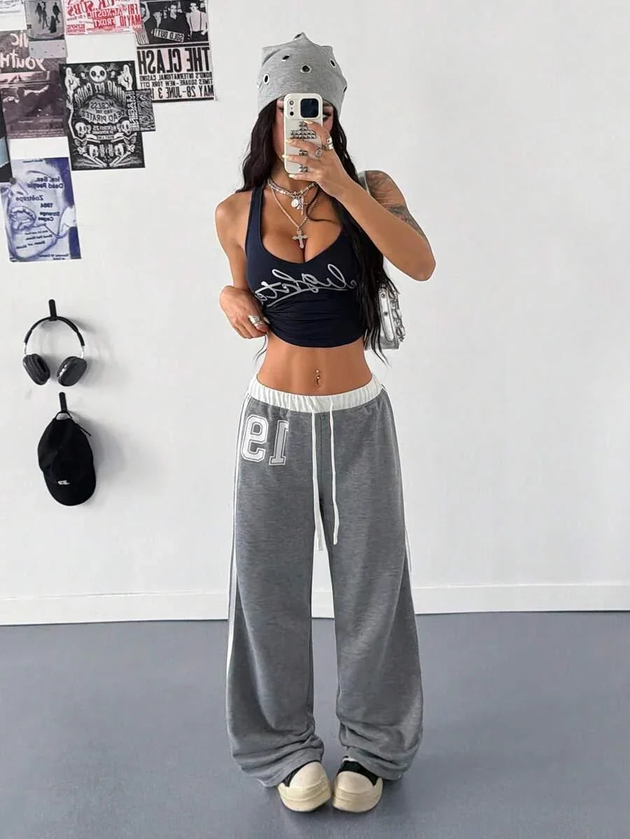 Model in gray cotton beanie and baggy HUSTLE801 'That Girl' sweatpants with black crop top