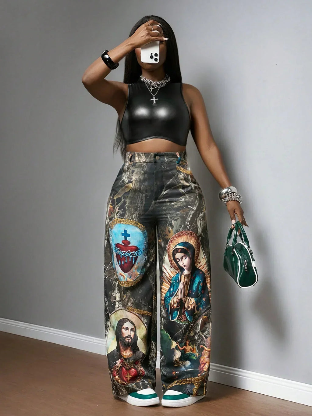 Black faux leather crop top and multicolor graphic print wide-leg pants, main colors black and green.