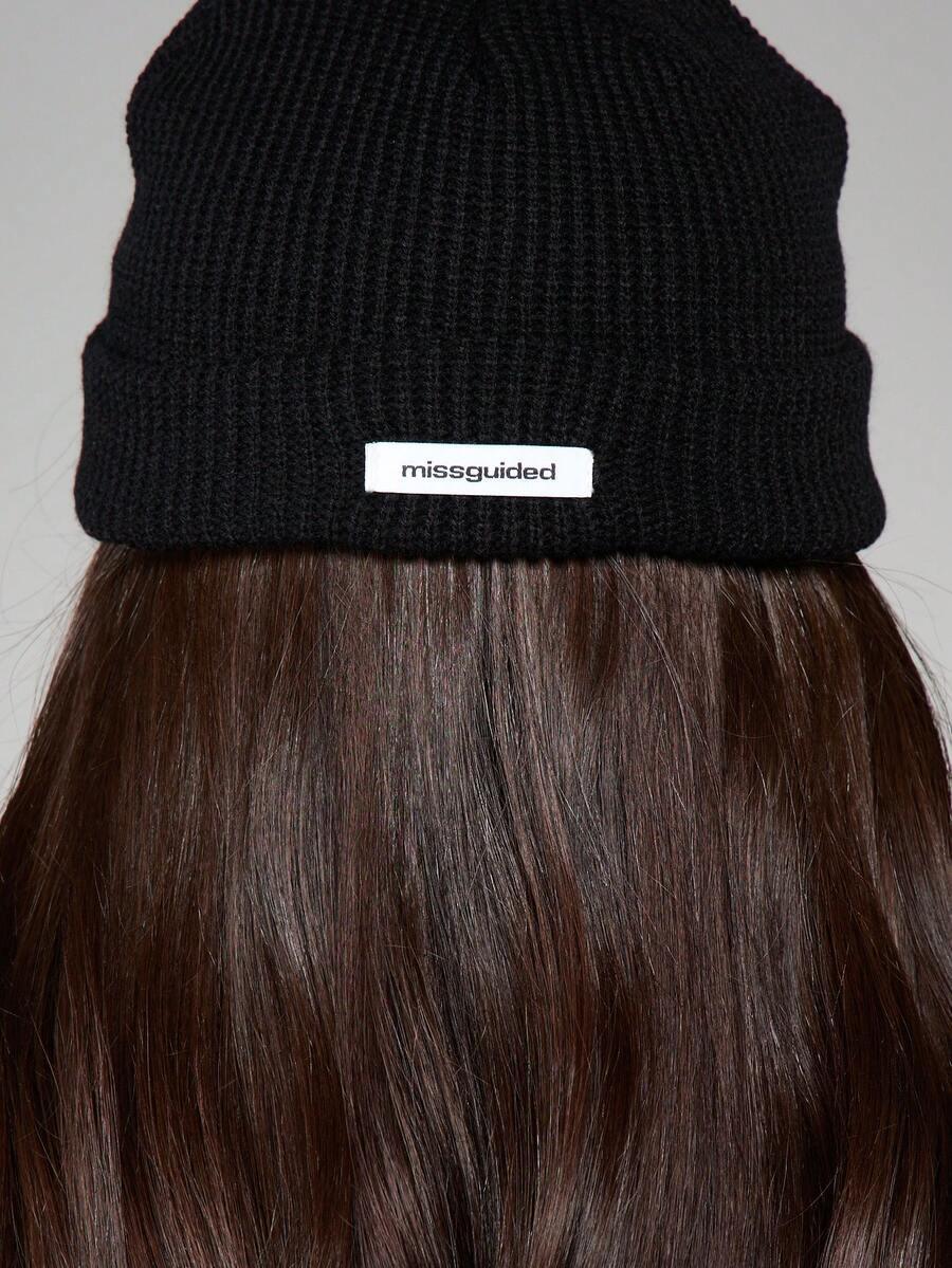 Black knit cotton beanie with 'missguided' label, worn over long brown hair, streetwear style