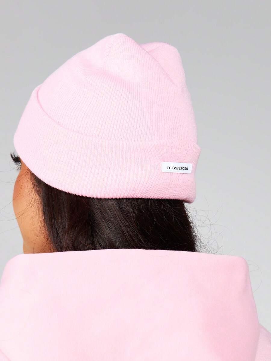 Pink cotton Missguided beanie with label, cozy streetwear accessory, worn by model, soft texture