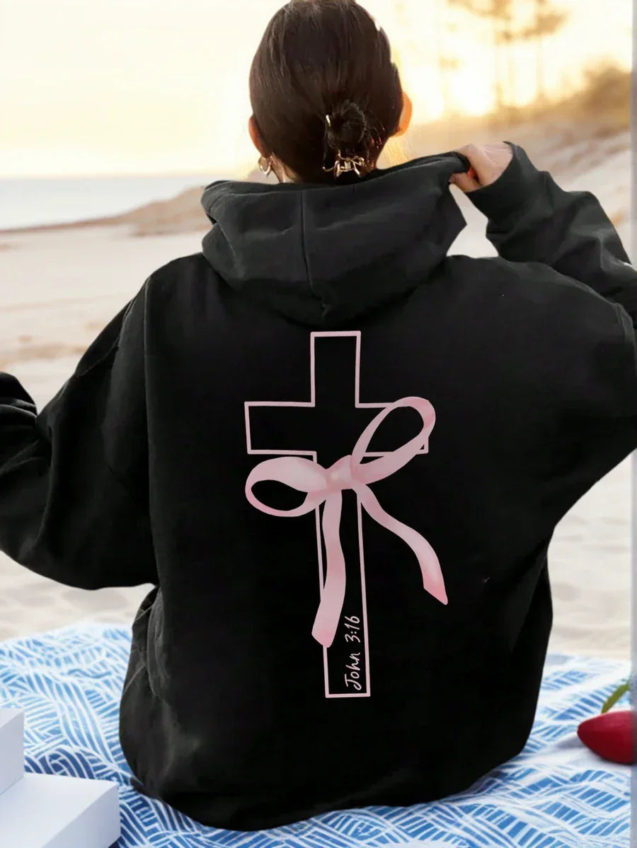 Black cotton hoodie with pink cross and bow design, John 3:16 text, beach background