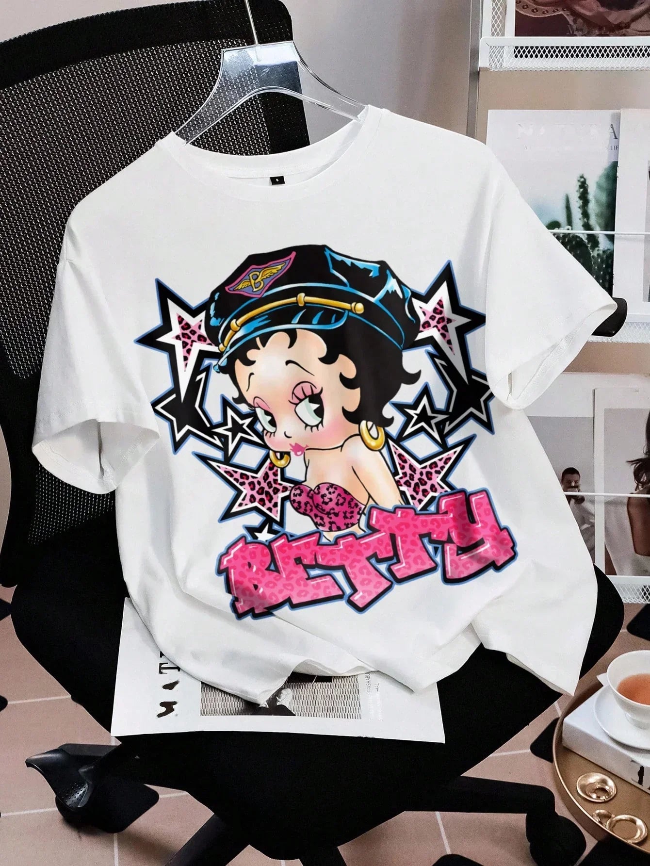 White cotton Betty Boop graphic tee with pink and black print on chair, HUSTLE801 streetwear
