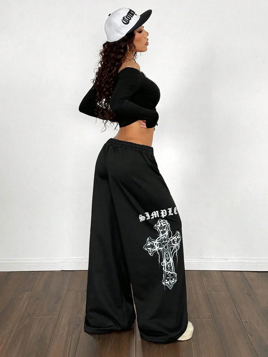 Black cotton SIMPLE cross wide leg pants with white graphic and oversized fit, model in HUSTLE801