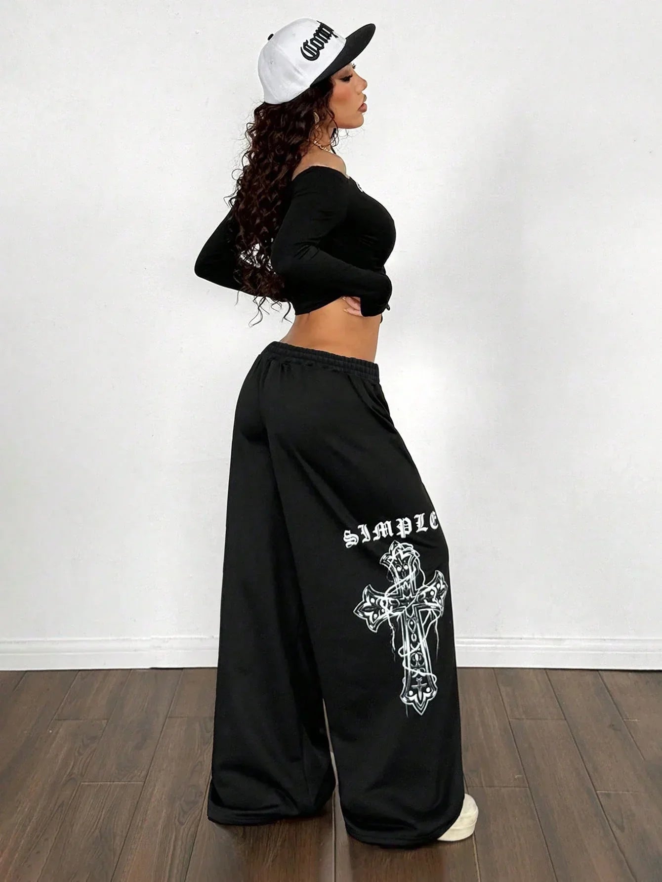 Black cotton SIMPLE cross wide leg pants with white graphic and oversized fit, model in HUSTLE801
