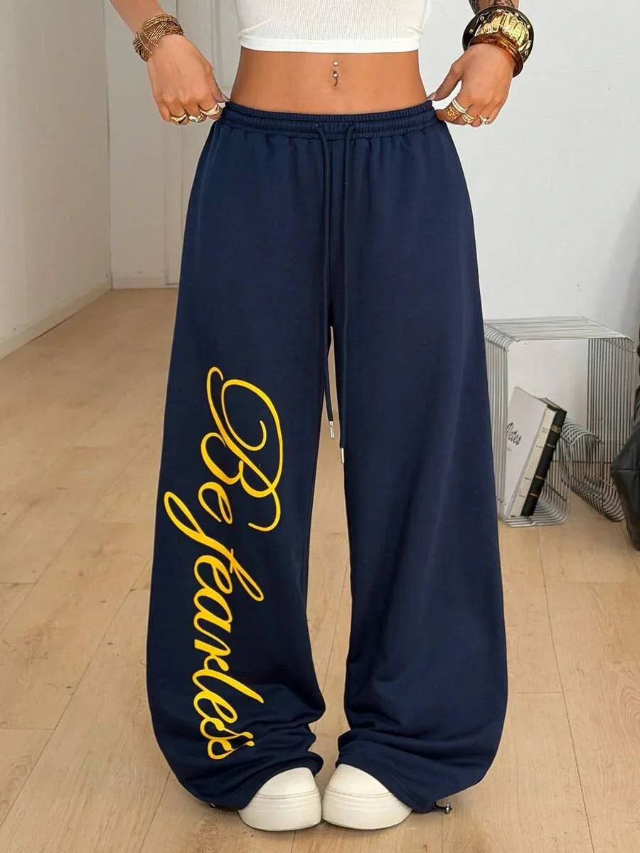 Navy cotton HUSTLE801 Be Fearless baggy sweatpants with yellow script and drawstring waist