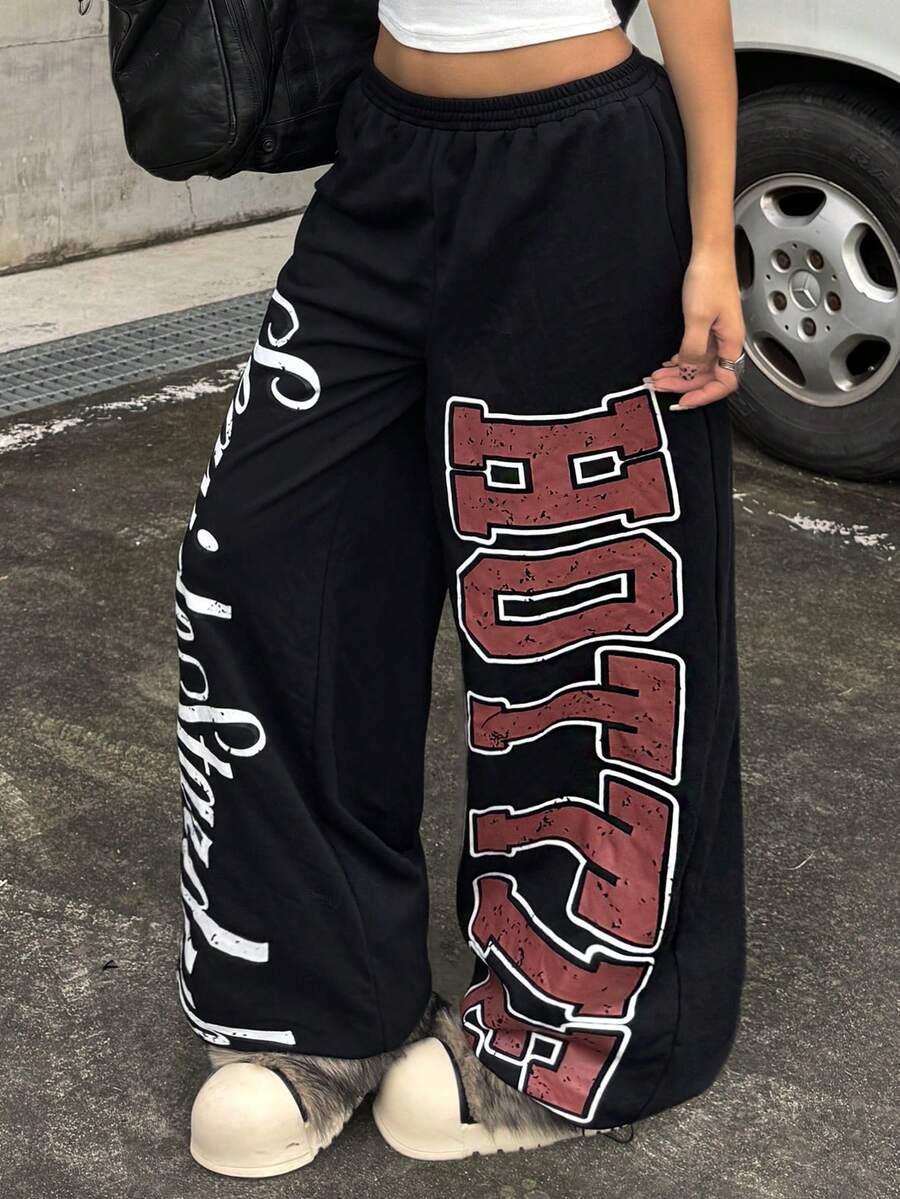 Black cotton HOTZZY wide leg sweatpants with bold red and white print, streetwear style