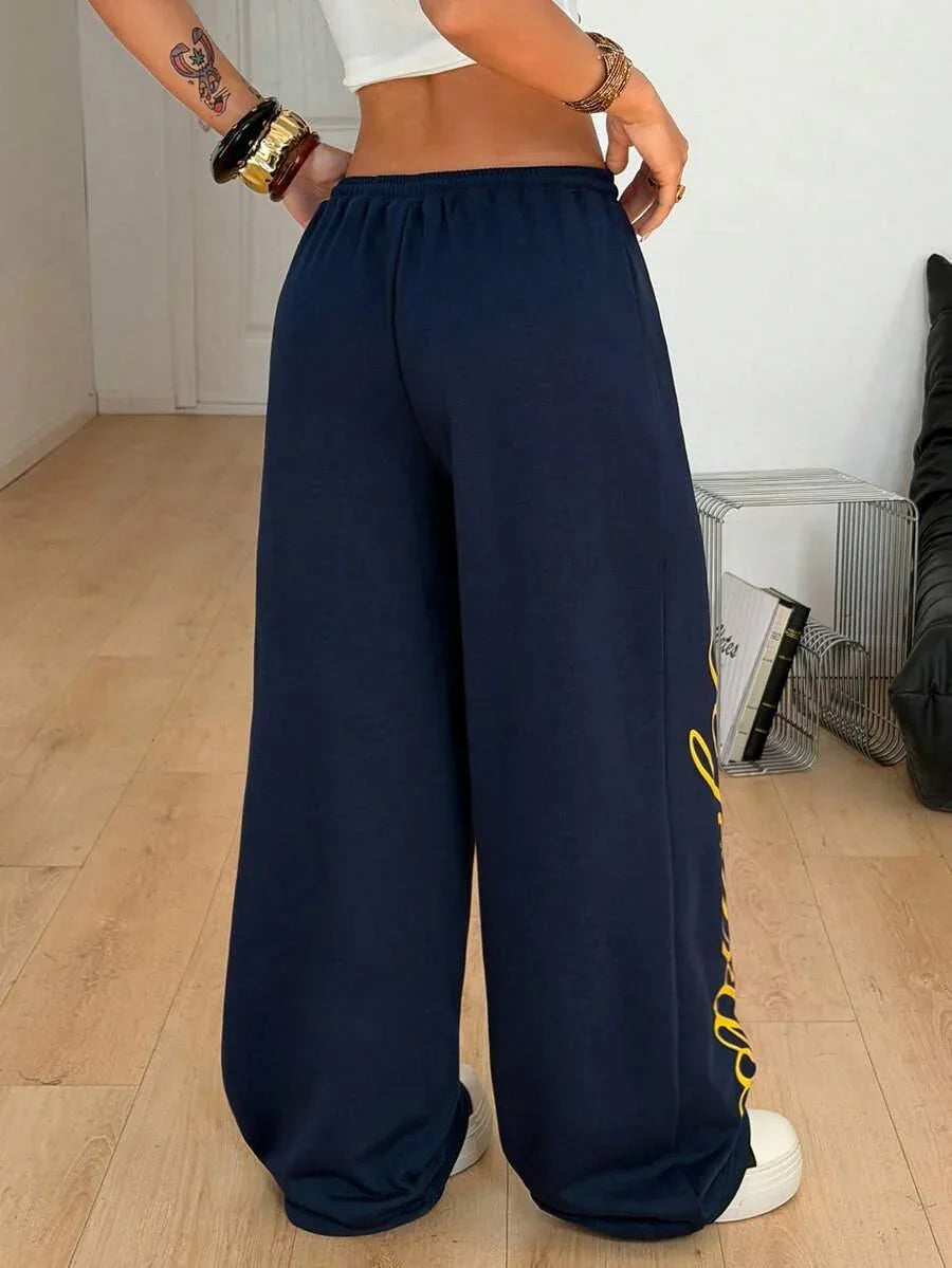 Navy blue HUSTLE801 baggy cotton sweatpants with yellow side script, casual streetwear style