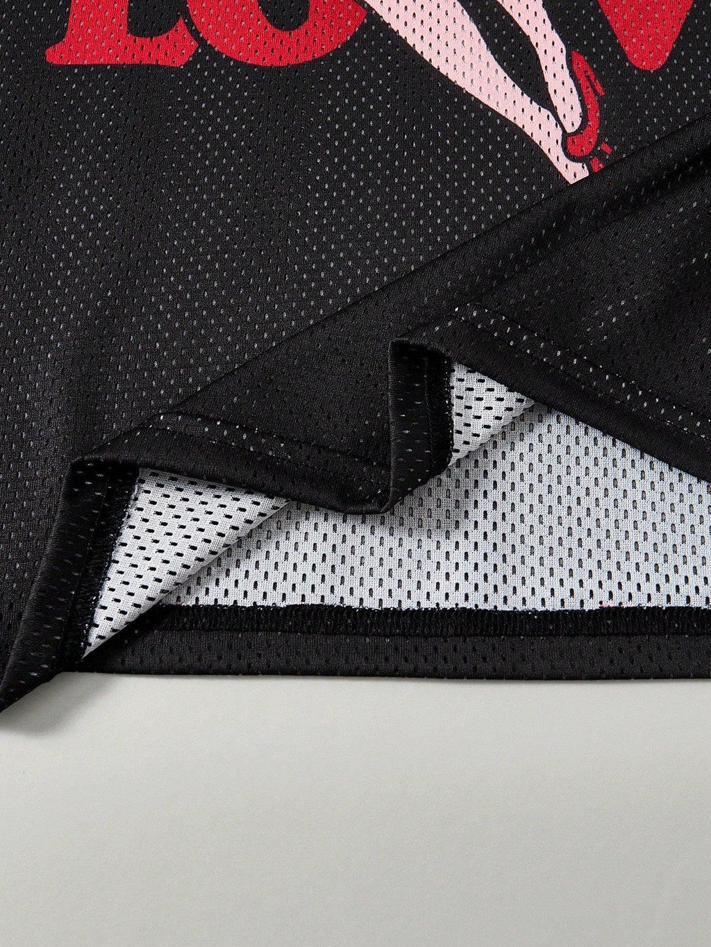 Black mesh cotton fabric closeup with red graphic and white lining from HUSTLE801 Love Jersey
