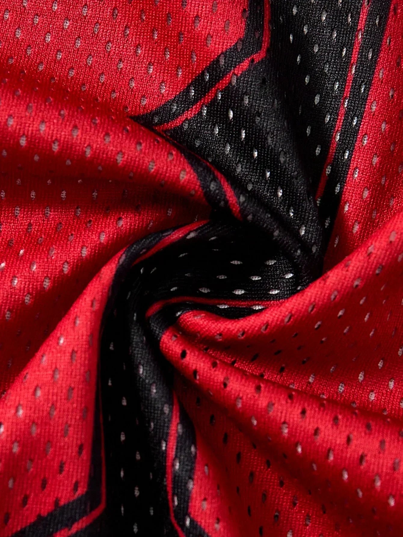 HUSTLE801 mesh fabric closeup, red and black polyester material with perforated texture